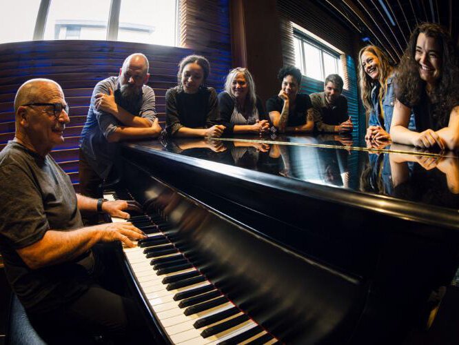 Alluvion staff photo at the house grand piano.