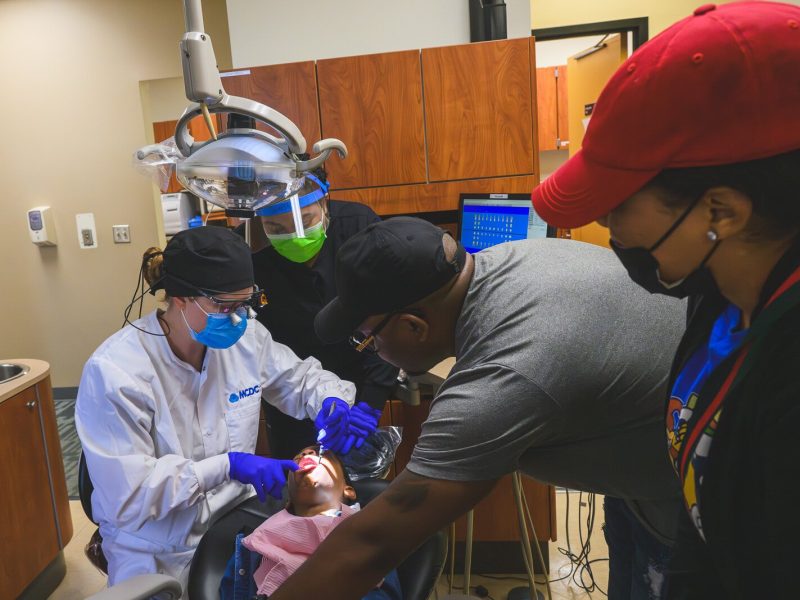 Dentist, Dr. Gina Tischendorf, takes a final peak at Giovanni's teeth.
