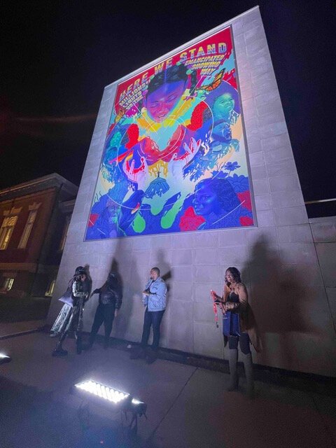 The artists, Jay Hero and jessica Care moore, and attendees at the mural's celebration on December 8