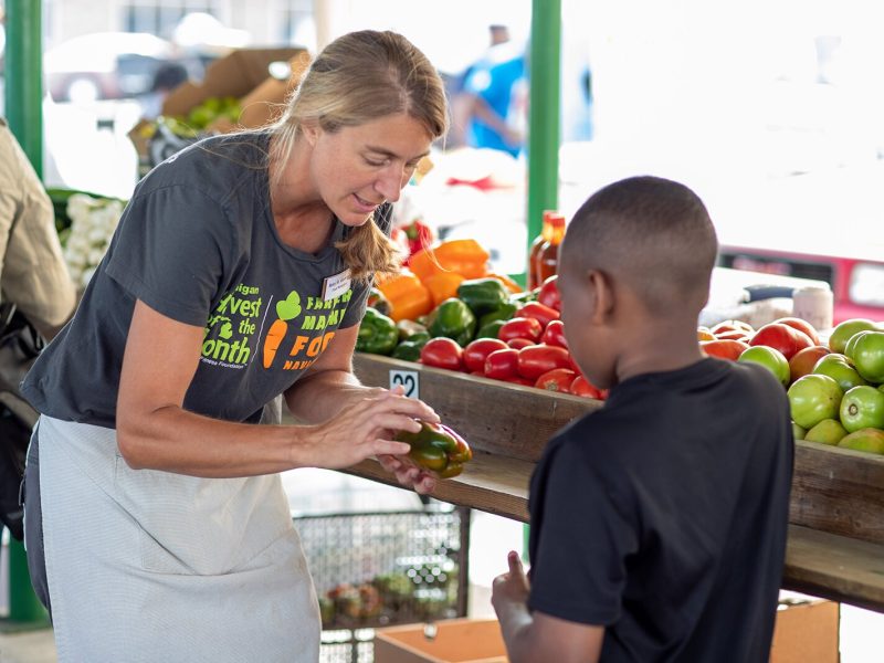 Amy St. Germain, a nutrition educator at the YMCA of Greater Grand Rapids, works as a Farmers Market Food Navigator at the Muskegon Farmers Market.