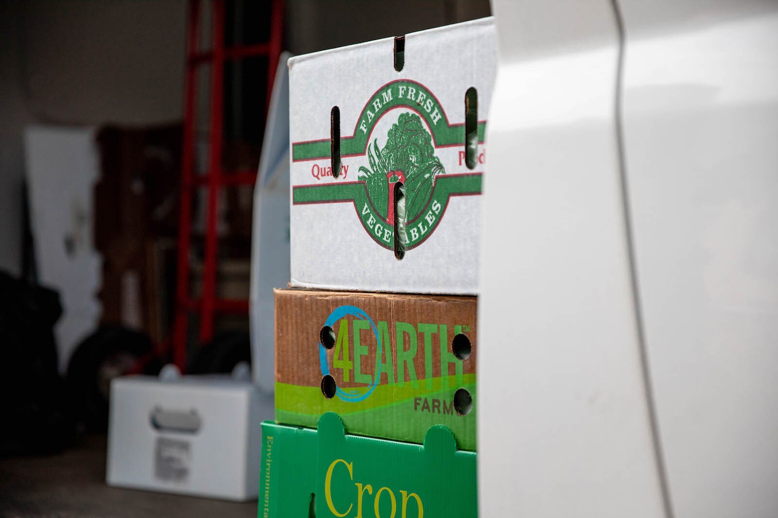 Produce boxes at a Michigan Farm to Family: CSA pickup at Lakeshore Depot.