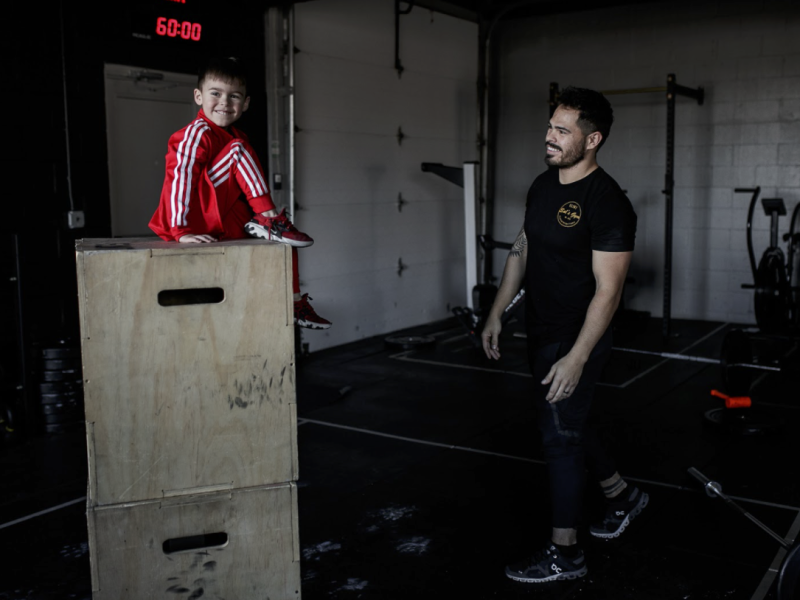 Jake Saldaña and his son play inside of Sal's gym.