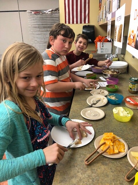 Traverse Heights students celebrate Innovation Day by creating and measuring ingredients for a healthy snack.