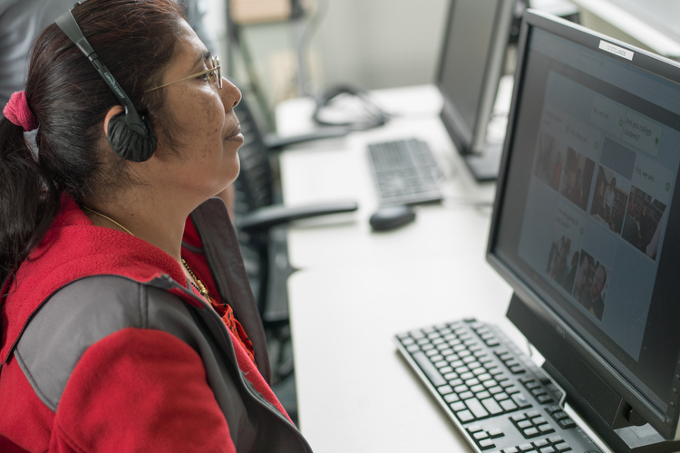 Shiva Bhattarai does language training on a computer at West Michigan Work! as part of a refugee education and jobs training program.