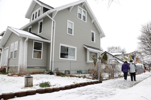Lorenzo Miguel walks with his wife, Emiliana Miguel-Cipriano in their neighborhood of Burton Heights