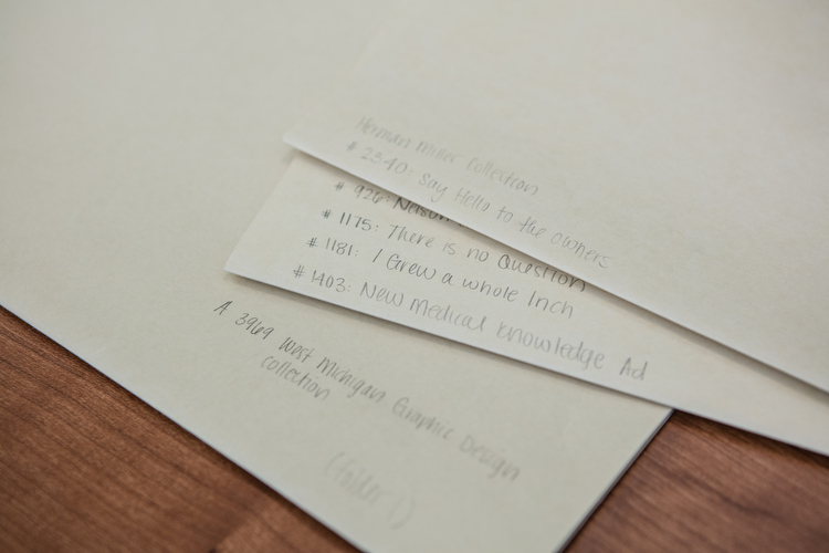 Notations on different sleeves for organizing the drawers in the archives.