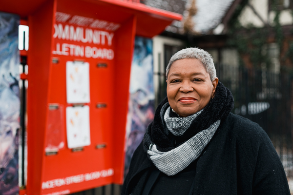 Denise Kennedy next to the Princeton Street community board