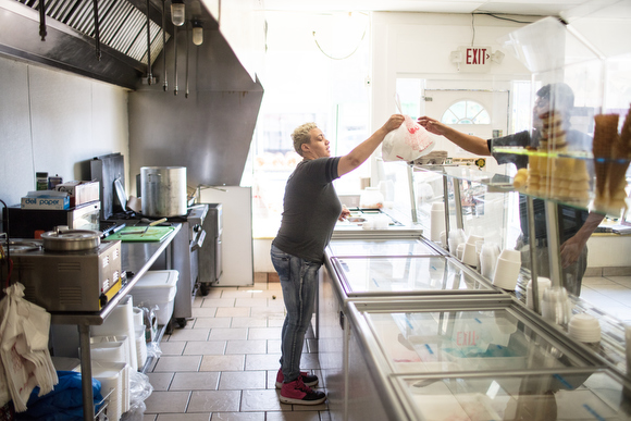 Marcia Gonzales prepares food for customers at Los 3 Mangos de Michoacan