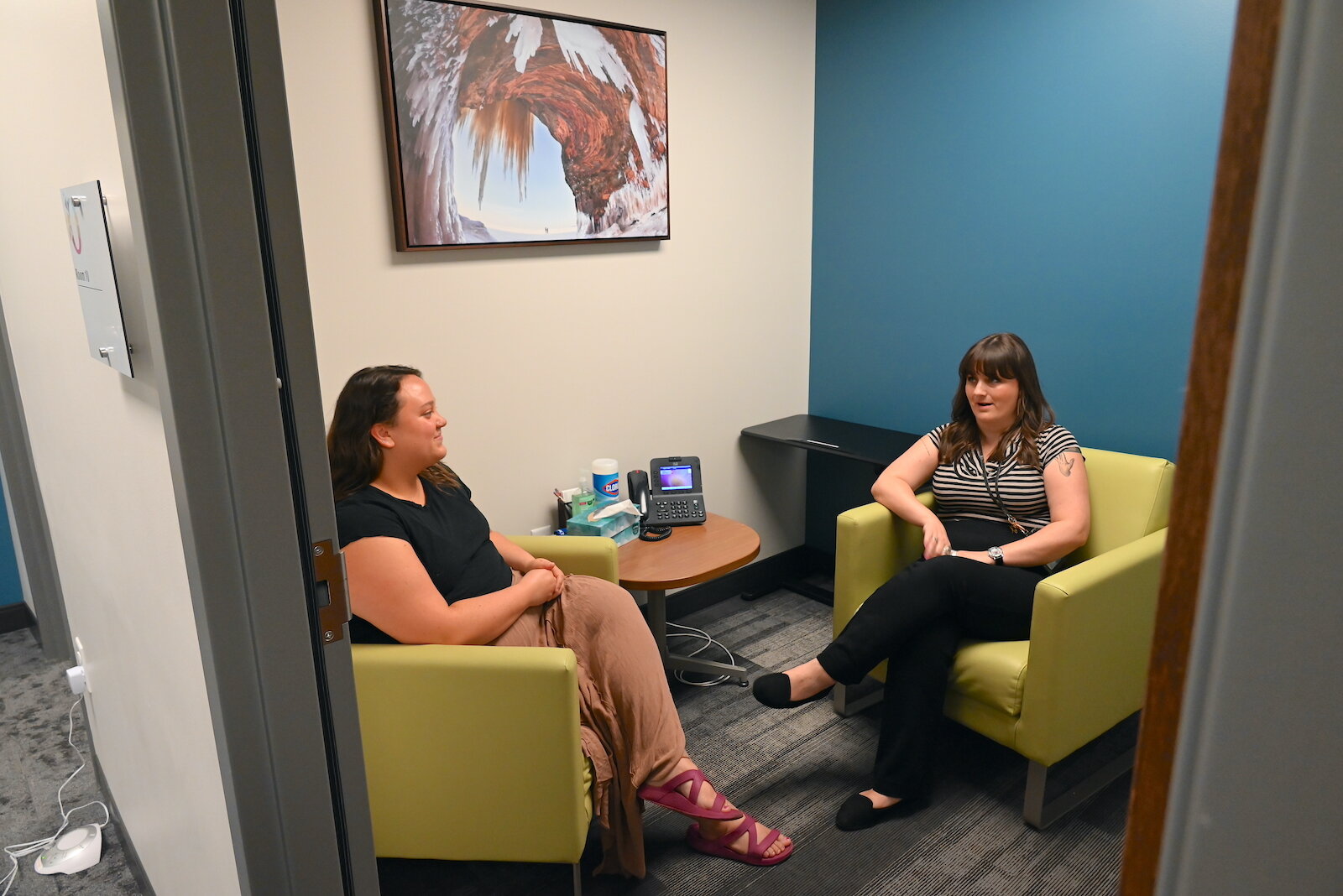 OnPoint staff, from left, Kaitlin Oakes and Alison Schuyler talk in room where staff and members of the public can meet comfortably.