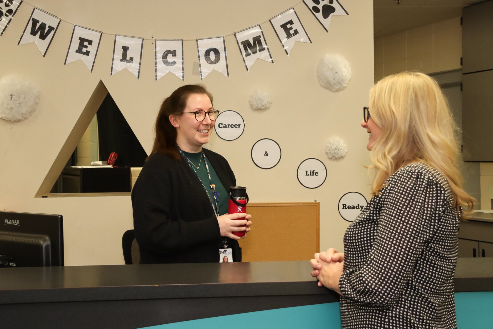 Kristin Graham (right) checks in with a member of her team.