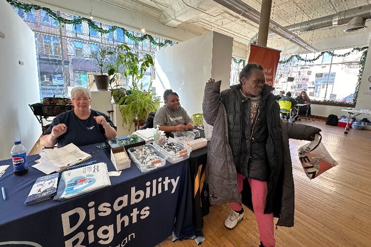 Rena Rogers does a little dance at the DRM vaccine clinic in Grand Rapids.