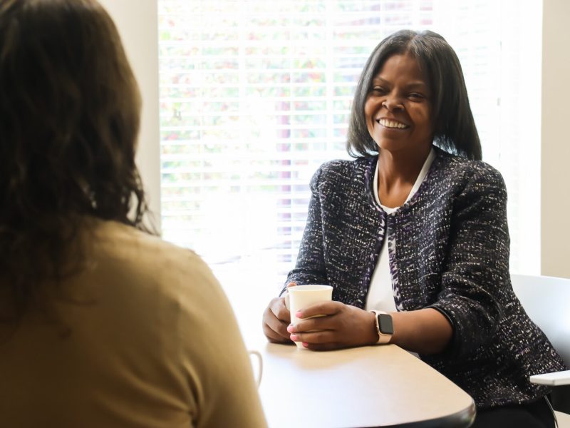 Datasha Chapman, a member of Calvin University's Lay Ambassadors for Mental Health program, chats with a colleague.