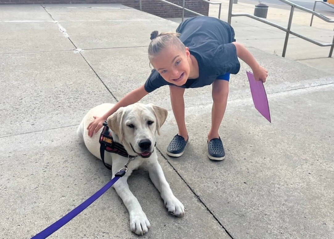 Jake, Birmingham Public Schools' new therapy dog, with Haven Zawaideh, a 7th grader at Derby Middle School.
