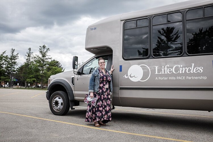 Sarah Milanowski with one of the LifeCircles buses. LifeCircles provides accessible medical transportation to the LifeCircles day center and to other specialty medical providers.