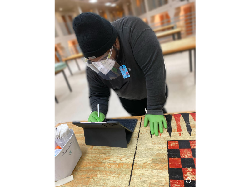 Antonio Cleveland, a disease intervention specialist with the Jail Health division of Wayne County’s Department of Health, Human, and Veterans Services, conducts COVID-19 contact tracing and testing for an individual booked into a Wayne County Jail.