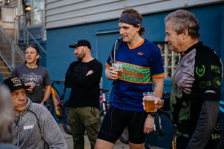 Members of the cycling group Spoke Junkies gather outside River's Edge Brewing Company in Milford after their bi-weekly ride.