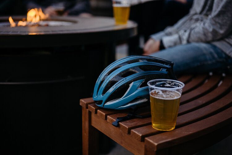 Members of the cycling group Spoke Junkies gather outside River's Edge Brewing Company in Milford after their bi-weekly ride.