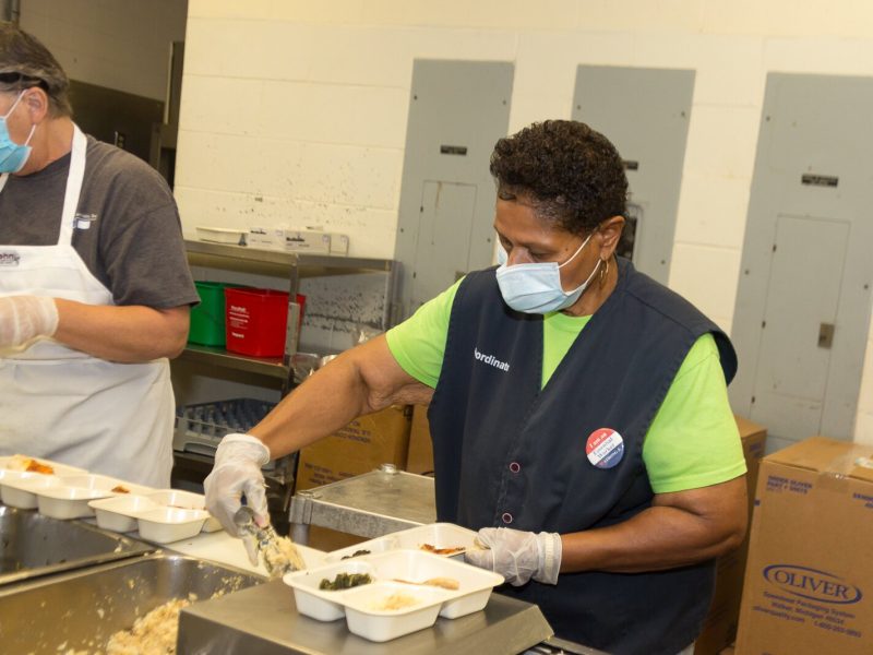 Doris Abbott, a volunteer for Senior Services Southwest Michigan, prepares meals for delivery.