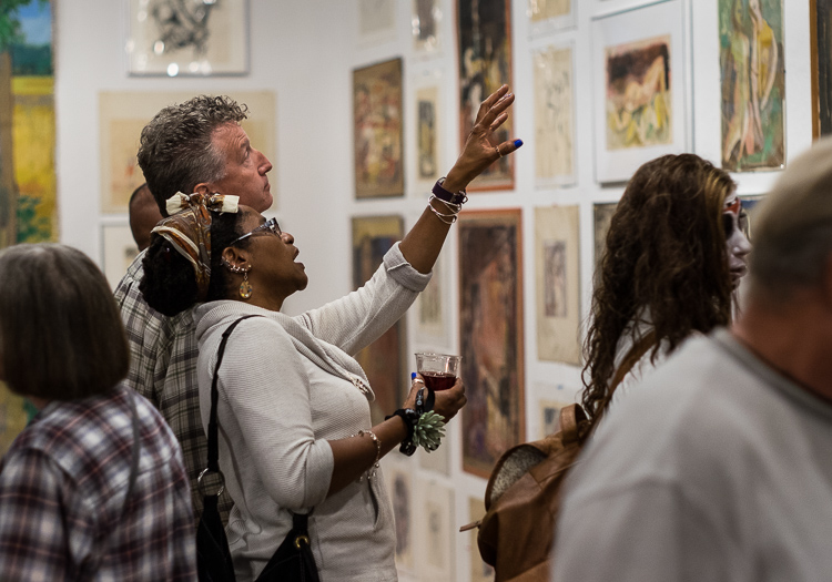 Eureka and Sean McCormick of Flushing study a work by Stefan Davidek at Bucham Gallery during the show's opening in coordination with ArtWalk.