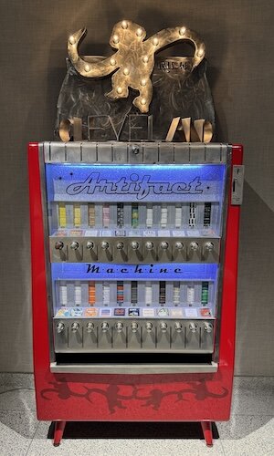 From "The Cleveland Artifact Machine IV" exhibit that was displayed at the gallery from October/November 2024, a vintage cigarette machine retooled by R!ch Cihlar to dispense cigarette package sized original works of art from 21 different artists.