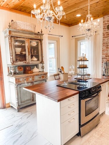 The kitchen boasts two refrigerators, a large oven and a stocked pantry.