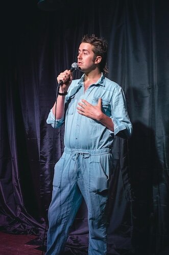 Murray performs a stand-up set on stage.