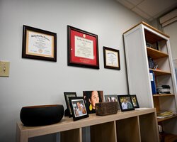 Harris' degrees hang above family photos in his office at Firelands Health.