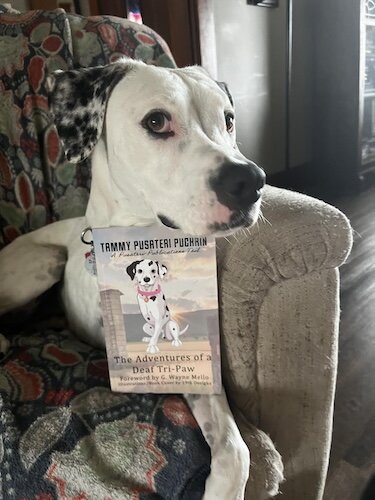 Gennie Marie shows off her owner's new book.