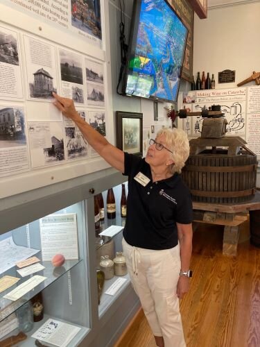 Jane Spriestersbach points out one of the displays at the Catawba Island Museum. (Photo/Kristina Smith)