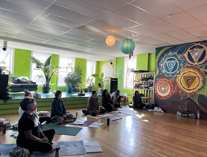 Members of the Yoga Instructor Program go through breathing exercises during a training session in November.