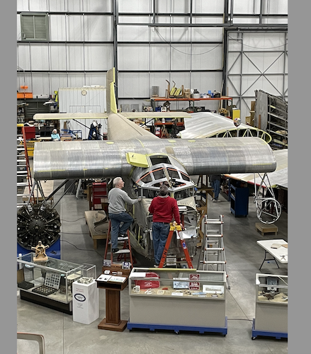 Since assembly of the Tri-Motor continues, this photo depicts the plane with no engines or wings and before what was finished was taken outside to be painted in the red, white and blue colors of Island Airlines. (Photo/Courtesy of TMHF)