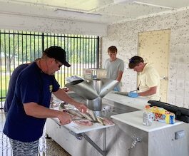 Anglers make use of the Mazurik Fish Cleaning Station. (Photo/Kristina Smith)