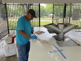 Anglers make use of the Mazurik Fish Cleaning Station. (Photo/Kristina Smith)