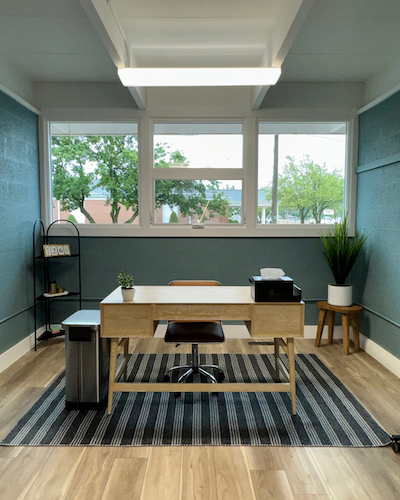 Natural light pours through a window in a private office at Work Space.
