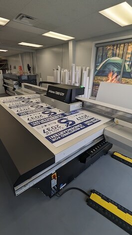 One of Loris' new machines is the Canon Arizona 1360 GTF, which is printing a 4x8 foot sheet of yard signs.