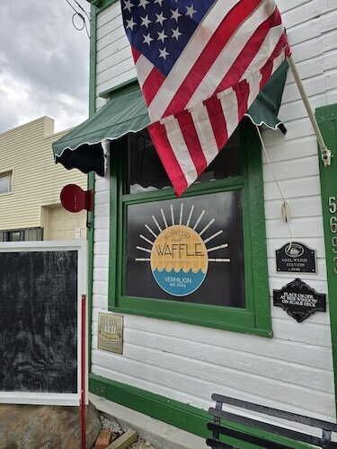 Vermilion Wake Up and Waffle is a concession stand with outdoor seating on Liberty Avenue.