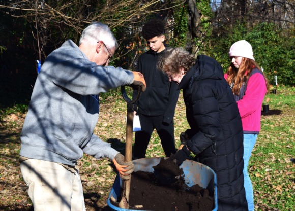 Young Bridge Builders volunteers learn planting techniques from volunteer master gardeners with the University of Tennessee. (Cole Bradley)