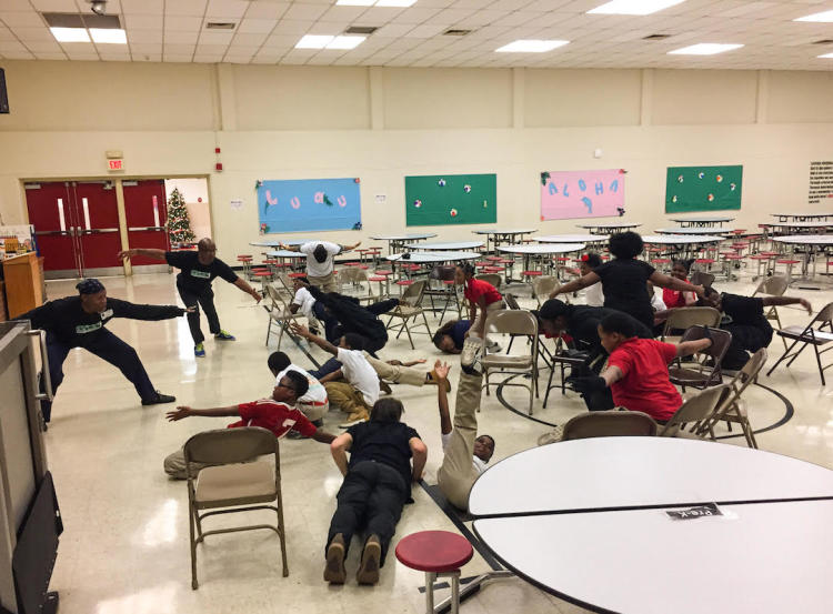 Frayser students and Playback Memphis actors strike a pose with each person creating their own unique interpretation of a "low and wide shape." (Cole Bradley)