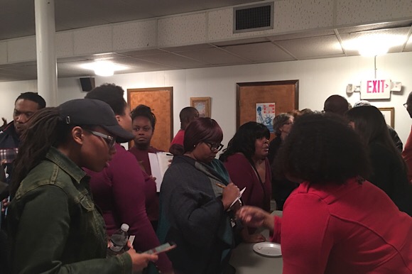 Members from the audience for Housing in Orange Mound: A Community Conversation, ask more questions post-event with specific panelists.