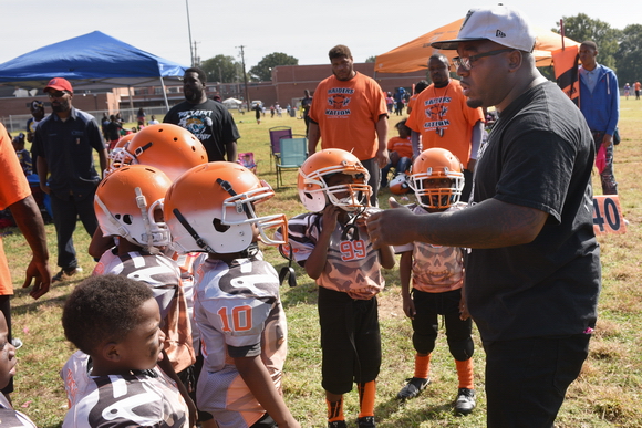 Orange Mound Raiders founder and coach Antonio Huntsman gives a pep talk to young football players in his sports and mentoring non-profit during a Saturday morning game.