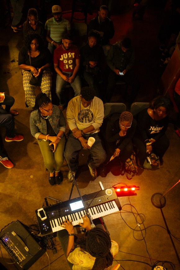 A crowd waits listens to music from reggae band Chinese Connection Dub Embassy as the weekly spoken word and open mic event, The Word, begins at The Den.