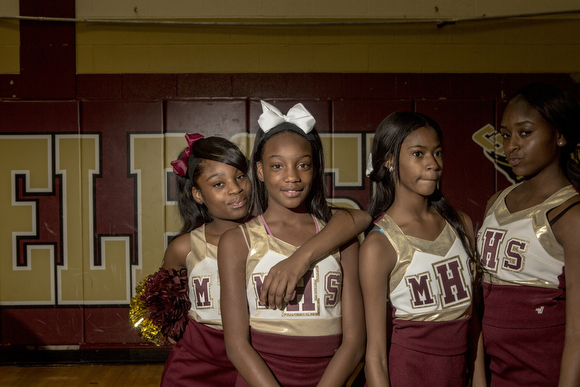 Cheerleaders take a moment between the action at the Melrose High School homecoming pep rally. (Andrea Morales)