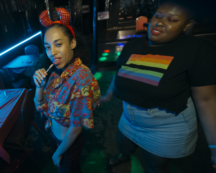 Club patrons lounge near Club Memphis dance floor awaiting vogue dance competition. Voguing is a dance style where performers imitate fashion model poses normally seen on runways.