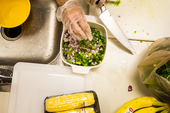 Kristin Fox-Trautman cuts onions and green peppers in the Kaleidoscope Kitchen in Binghampton.