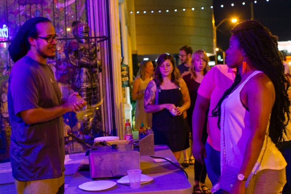 Rico Fields serves a line of hungry concert-goers during Soul Roll Saturdays at the Hi-Tone Cafe.