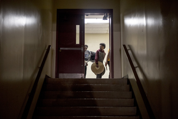The Melrose High School marching band lines up in the hallway before a performance at a fundraiser for the band.