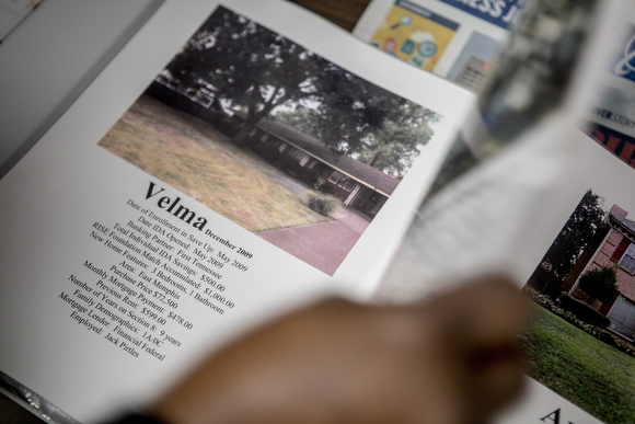 Linda Williams flips through a folder of homes that have been purchased by folks with the help of RISE Memphis financial literacy programs.