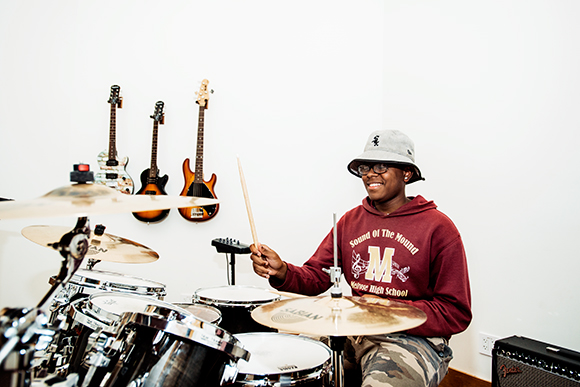 Jermey Wilbourne plays the drums in Cloud901's recording studio.