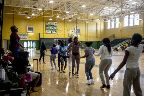 Principal Alisha Kiner jumps in to help some students in a double dutch jump rope session in the gym at Booker T. Washington.