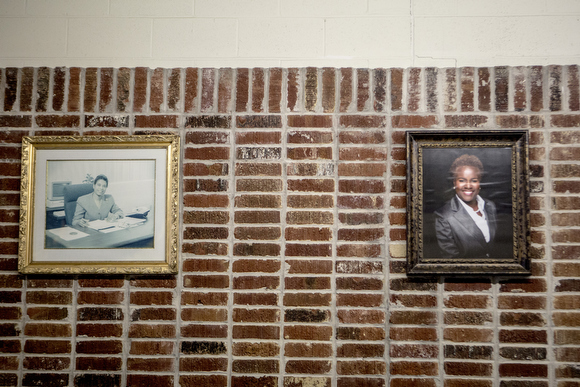 Principal Alisha Kiner's portrait hangs on the wall alongside her predecessors. She is the second woman to serve as principal at the school.